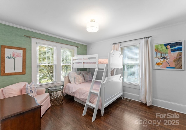 bedroom with multiple windows, baseboards, dark wood-style flooring, and ornamental molding