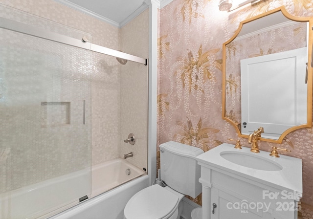 bathroom with wallpapered walls, toilet, shower / bath combination with glass door, crown molding, and vanity