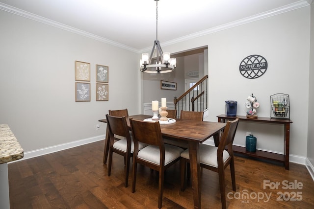 dining space featuring crown molding, dark wood-type flooring, and a chandelier