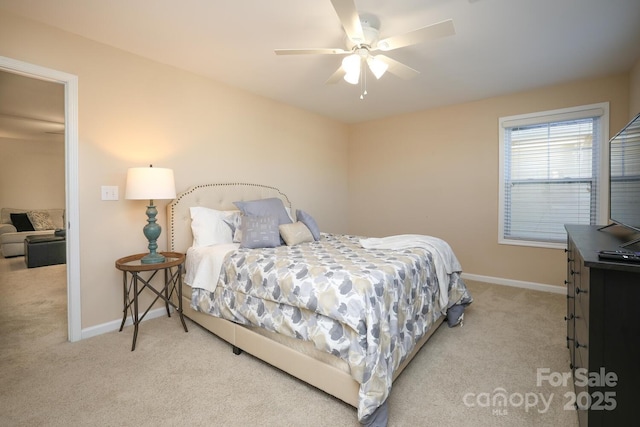 bedroom with ceiling fan and light carpet