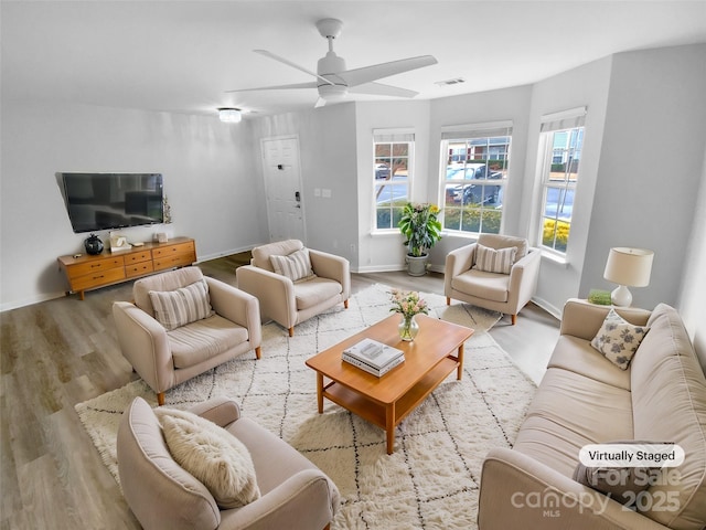 living room with ceiling fan and light hardwood / wood-style floors