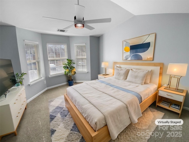 carpeted bedroom with ceiling fan and vaulted ceiling