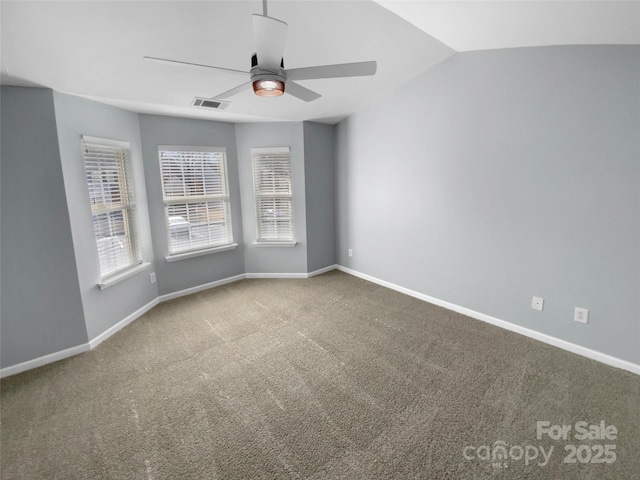 carpeted empty room featuring vaulted ceiling and ceiling fan