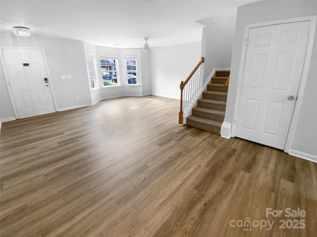 unfurnished living room featuring hardwood / wood-style flooring and ceiling fan