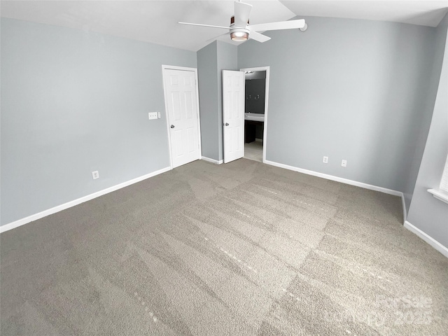 spare room featuring vaulted ceiling, carpet floors, and ceiling fan