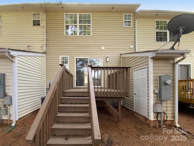 rear view of house featuring a deck