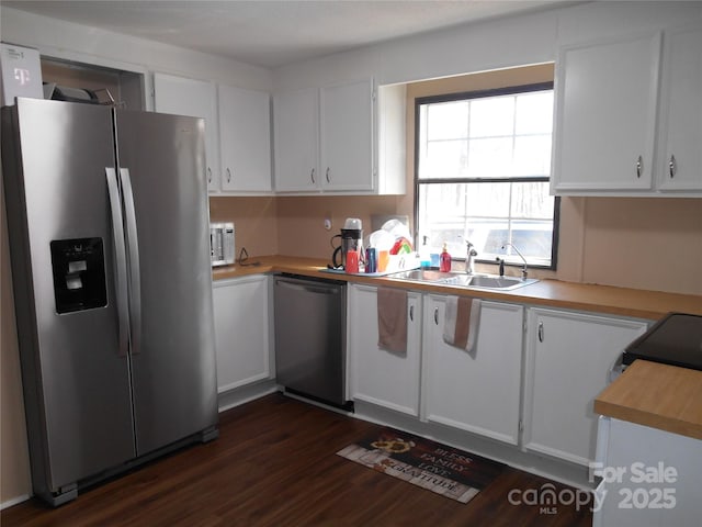 kitchen with white cabinetry, sink, dark wood-type flooring, and stainless steel appliances