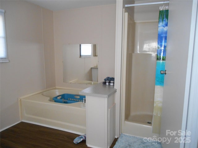 bathroom with wood-type flooring and walk in shower