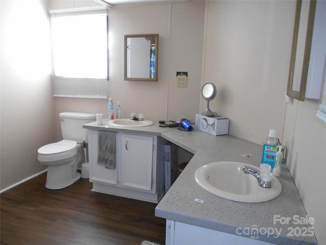 bathroom featuring vanity, hardwood / wood-style floors, and toilet