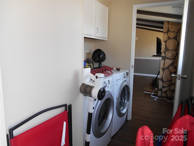 laundry area with cabinets, washing machine and clothes dryer, and dark hardwood / wood-style flooring