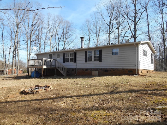 view of front of house with a deck and a front lawn