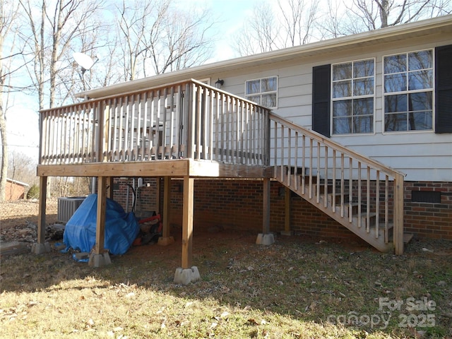 rear view of house with cooling unit and a deck