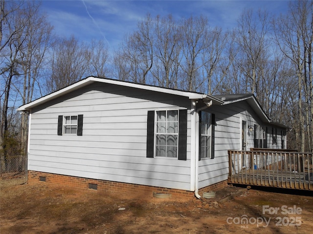 view of home's exterior with a wooden deck