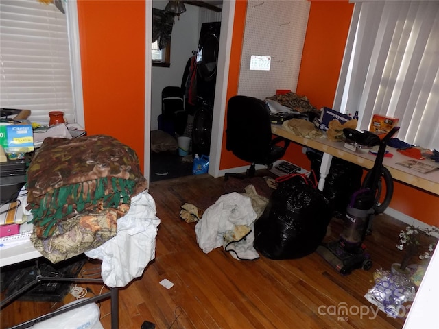 bedroom featuring wood-type flooring and a closet