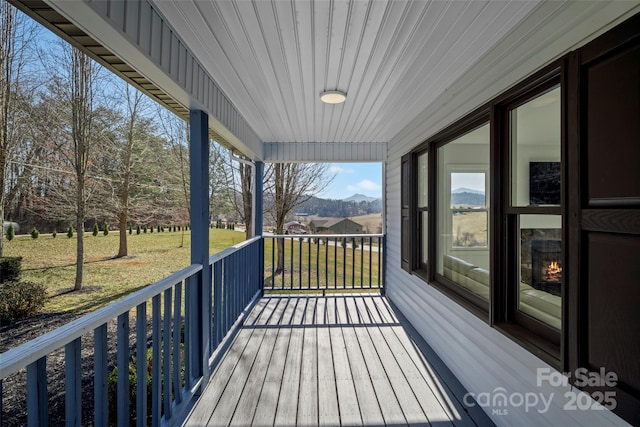 wooden terrace with a yard