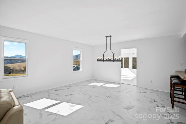 dining space featuring a mountain view and a chandelier