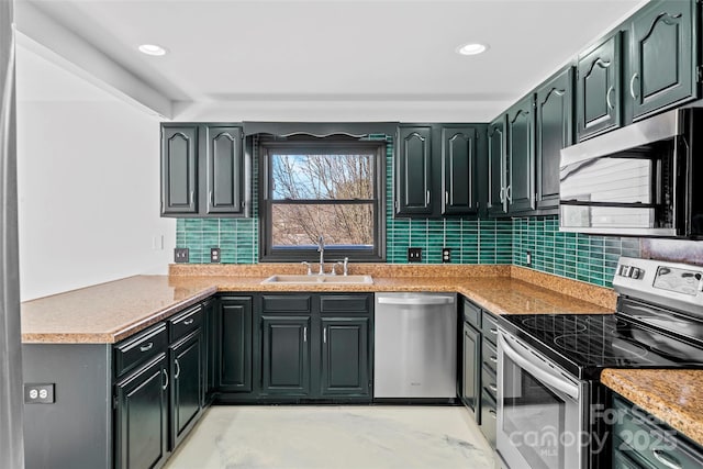 kitchen with light stone counters, sink, backsplash, and stainless steel appliances