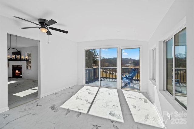 interior space with vaulted ceiling and ceiling fan