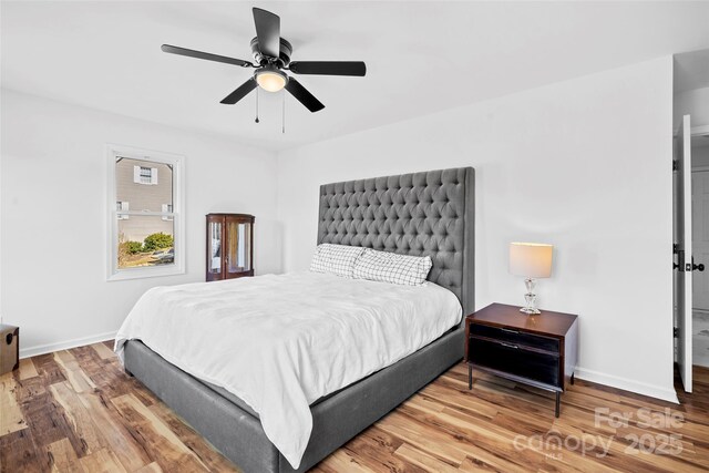 bedroom with hardwood / wood-style flooring and ceiling fan