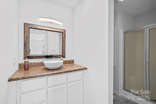 bathroom featuring vanity and a shower with door