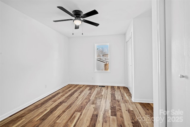 spare room featuring ceiling fan and light wood-type flooring