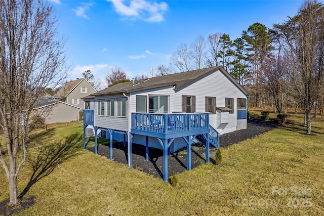 back of house with a wooden deck and a lawn