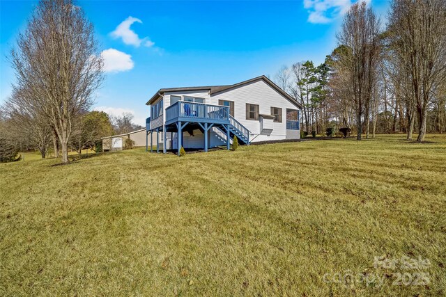 back of house with a yard and a deck