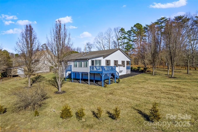 back of property featuring a yard and a deck