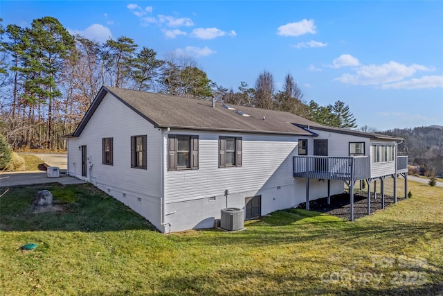 rear view of property with a yard, central AC, and a deck