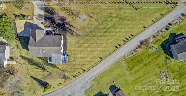 birds eye view of property with a rural view