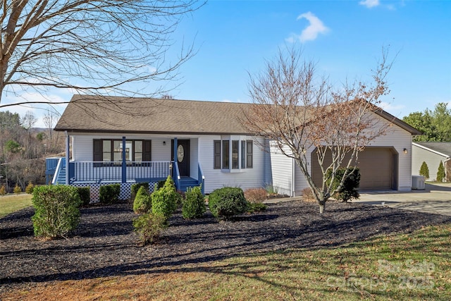 ranch-style house with central AC unit, a garage, and covered porch