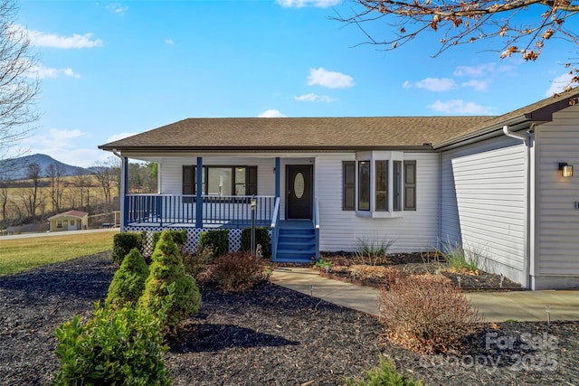 single story home with a mountain view and covered porch