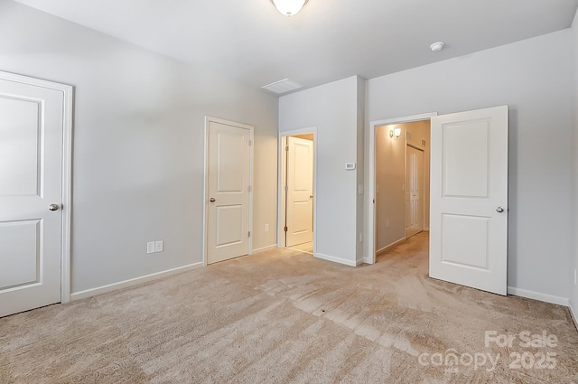 unfurnished bedroom with light colored carpet