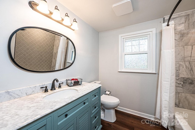 full bath featuring curtained shower, toilet, wood finished floors, vanity, and baseboards