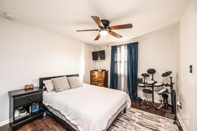 bedroom with dark wood finished floors, baseboards, and ceiling fan