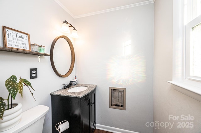 bathroom with toilet, baseboards, crown molding, and vanity