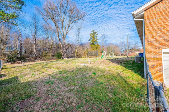 view of yard featuring a playground and fence