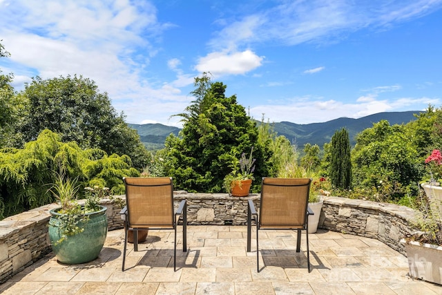 view of patio / terrace featuring a mountain view