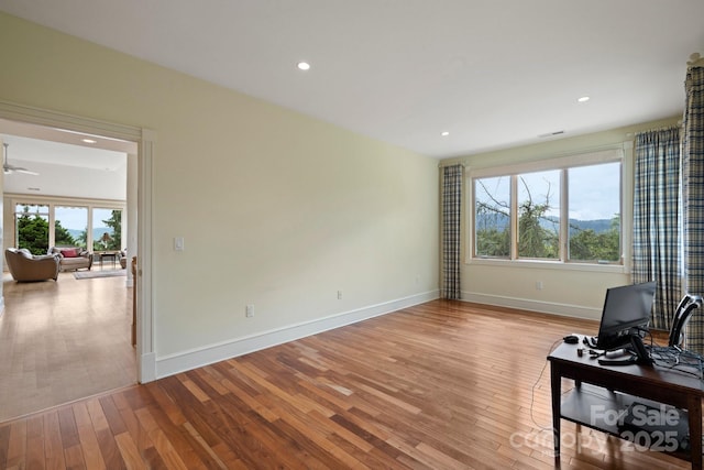 living room with ceiling fan and light wood-type flooring