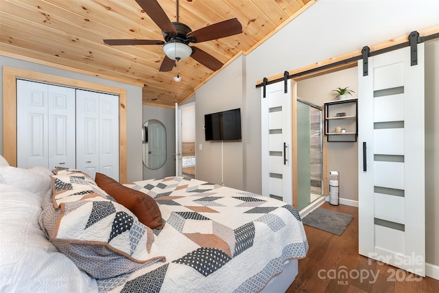 bedroom featuring dark wood-type flooring, lofted ceiling, wood ceiling, a closet, and a barn door