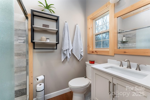 bathroom featuring vanity, a shower, and toilet