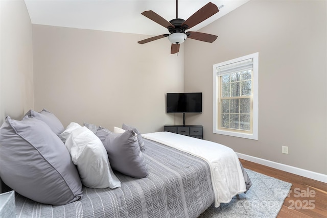 bedroom with lofted ceiling, dark wood-type flooring, and ceiling fan