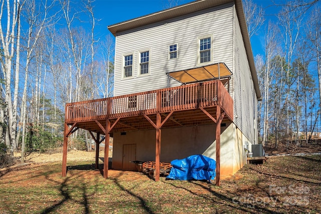 rear view of house with a wooden deck and central AC