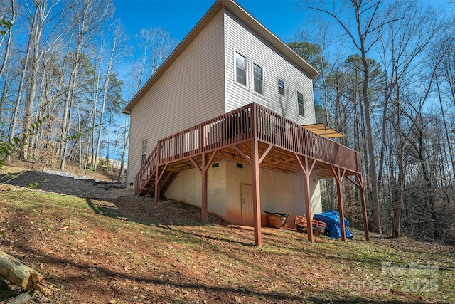 rear view of house featuring a wooden deck