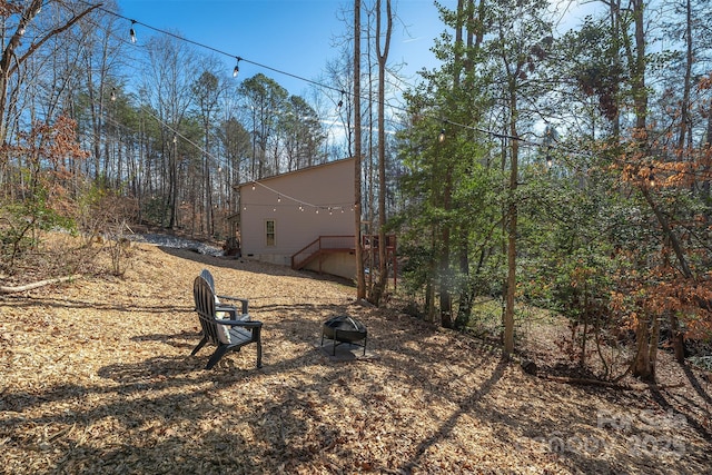 view of yard with an outdoor fire pit