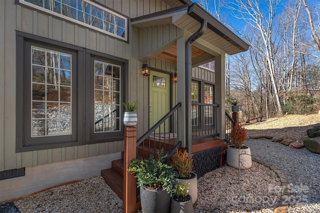 property entrance featuring board and batten siding