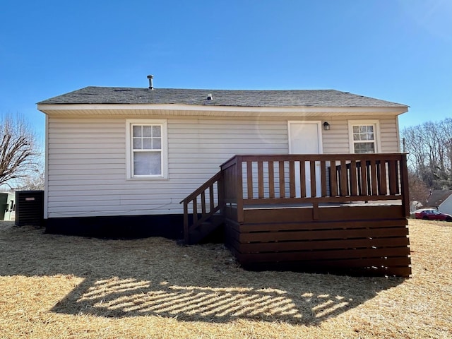 rear view of house featuring a wooden deck