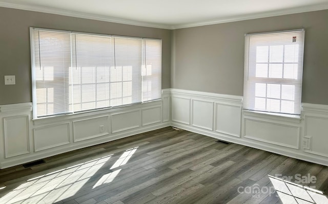 empty room featuring crown molding and light hardwood / wood-style flooring