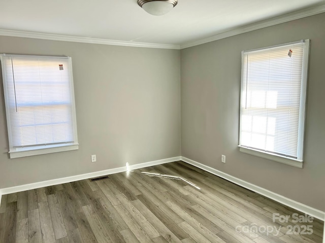 unfurnished room with hardwood / wood-style flooring and ornamental molding