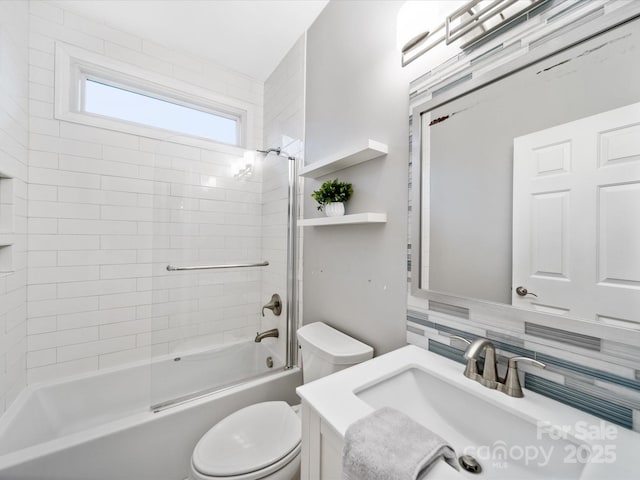 full bathroom with vanity, decorative backsplash, toilet, and tiled shower / bath